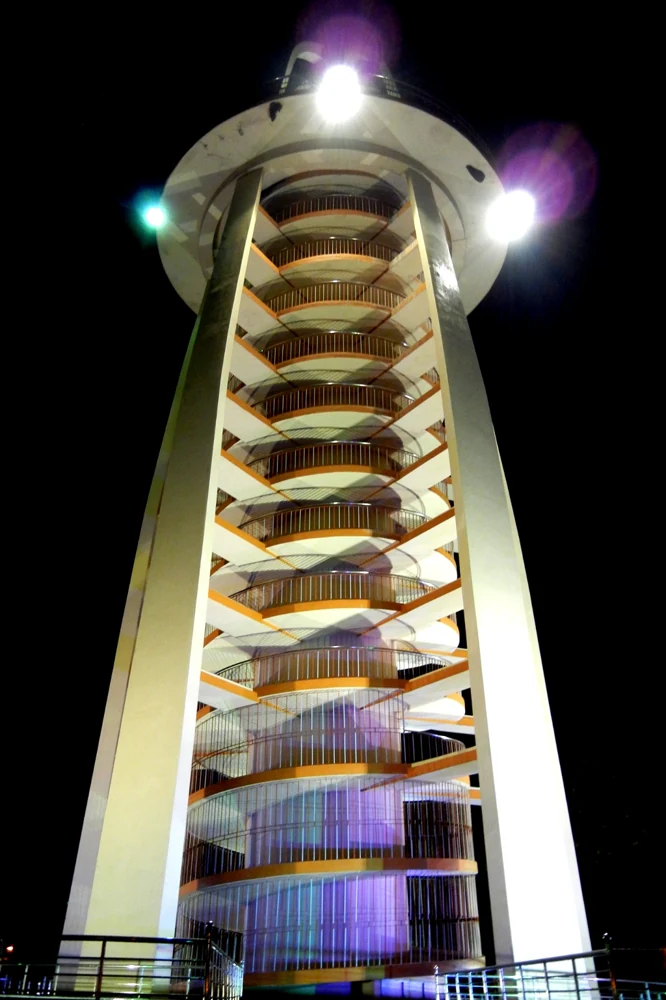 The spiral Anna Nagar Tower illuminated at night