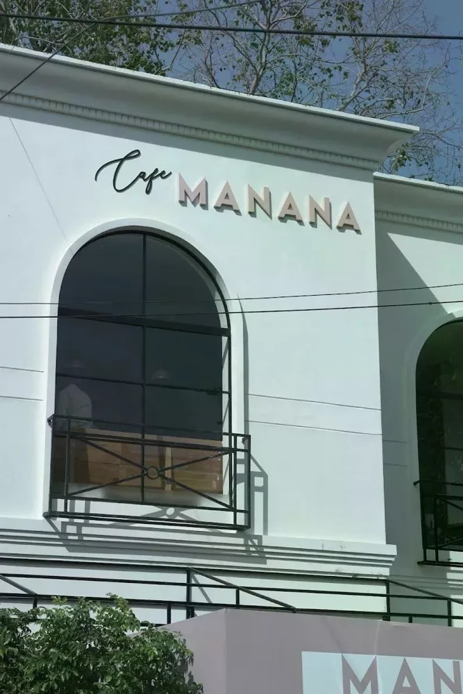 Café Manana’s cream façade and arched windows in Anna Nagar East